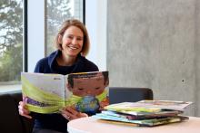 A woman reading childrens picture books