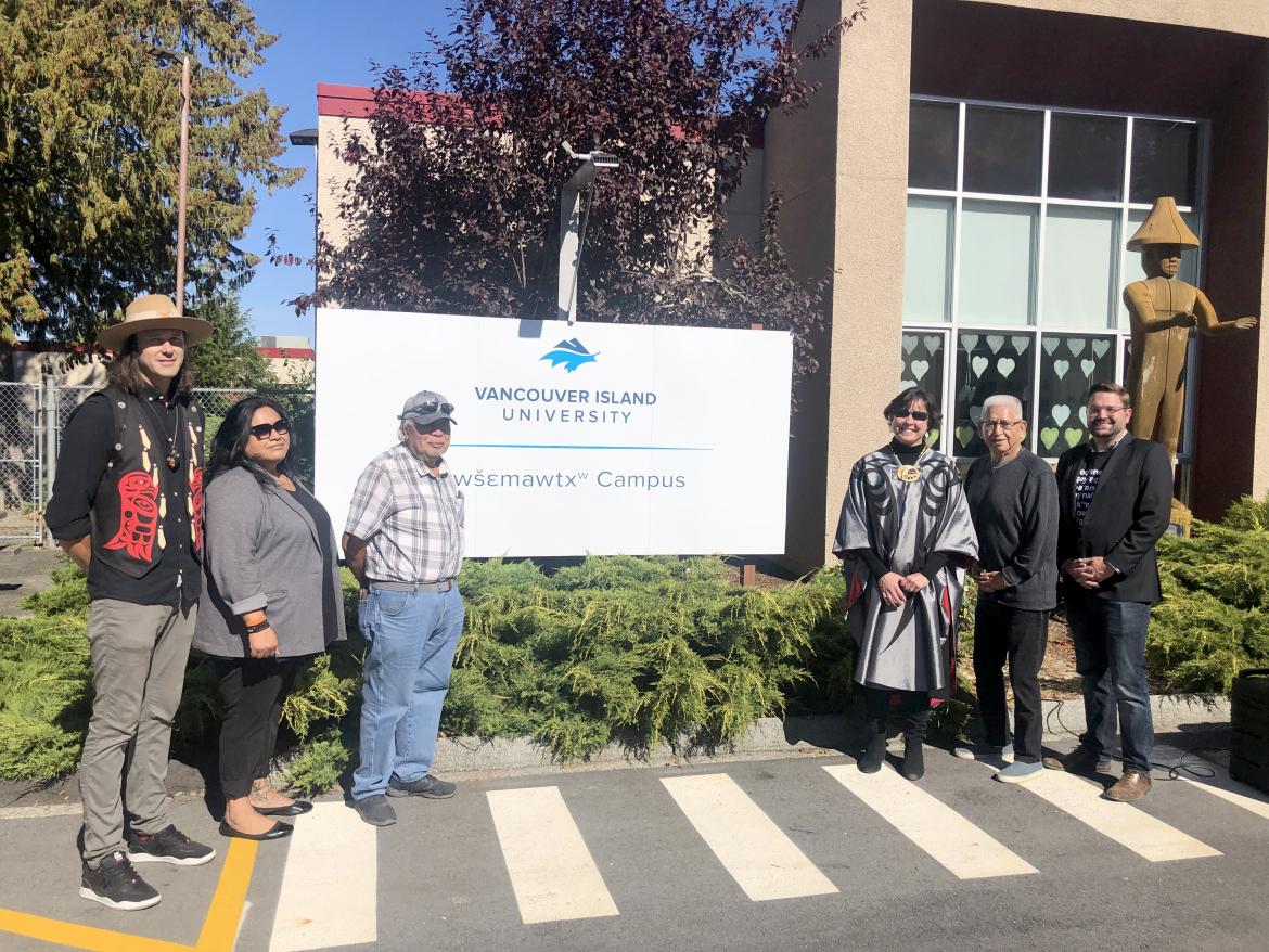 Group photo around the new sign at VIU’s campus in the qathet region
