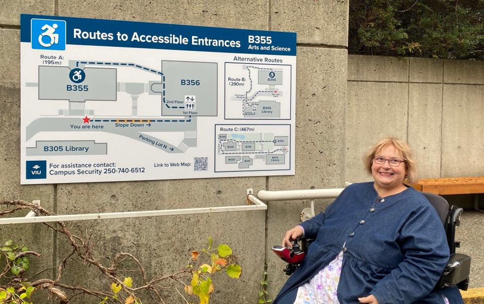 Dr. Linda Derksen with wayfinding signage