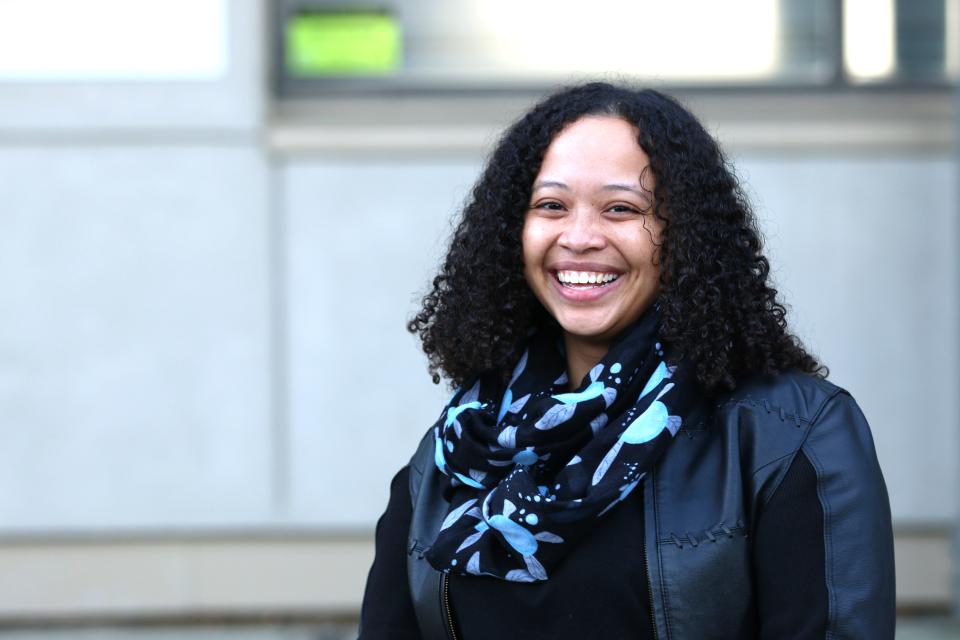 Felicia Fischer in front of the Master of Community Planning program building