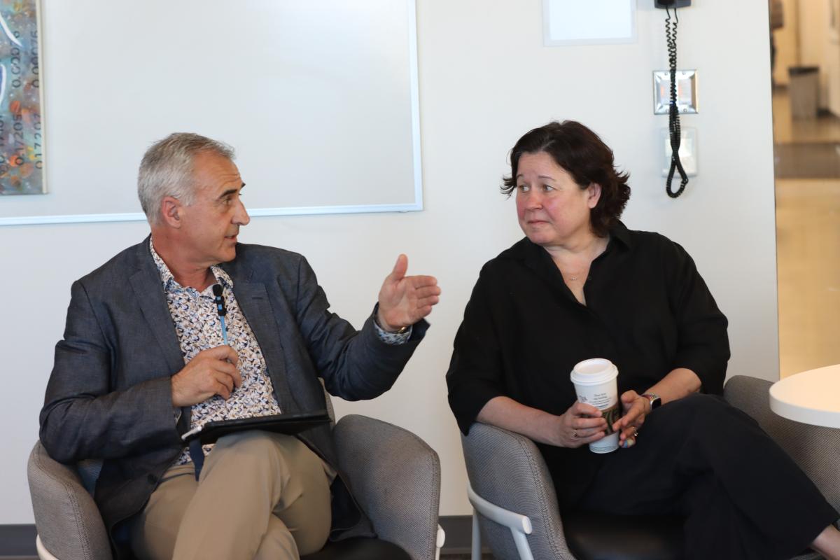 two people seated talk to one another, on the left is VIU Provost and Vice-President Academic Dr. Michael Quinn, on the right is VIU President and Vice-Chancellor Dr. Deborah Saucier