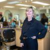 Dr. Sally Vinden stands inside a hair salon classroom